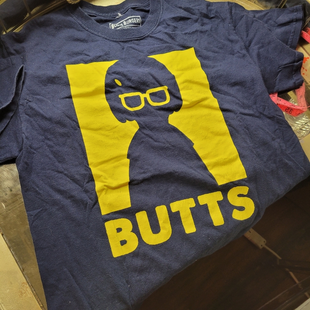 Bob's Burgers Tina "BUTTS" shirt.